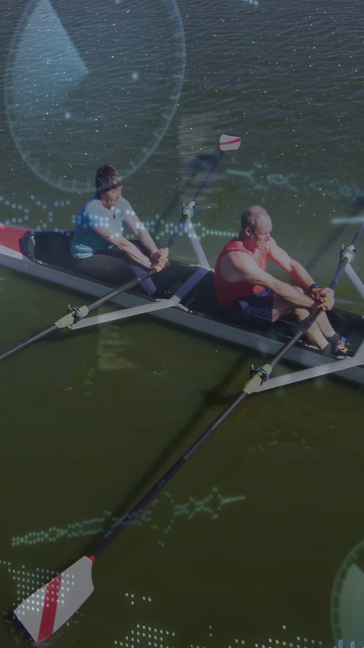 Rowing senior rowers wearing blue and red tops powering shell on calm lake, red-white oars overlays