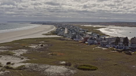 wells maine aerial v3 cinematic dolly in shot, drone fly along atlantic avenue capturing oceanfront residential houses and cottages towards horizon during daytime - october 2020