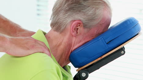 Physiotherapist-doing-back-massage-to-his-patient