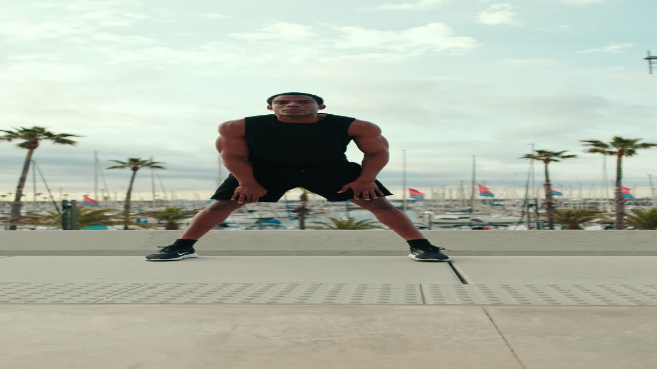 Young Fit Black Man Stretches by Marina