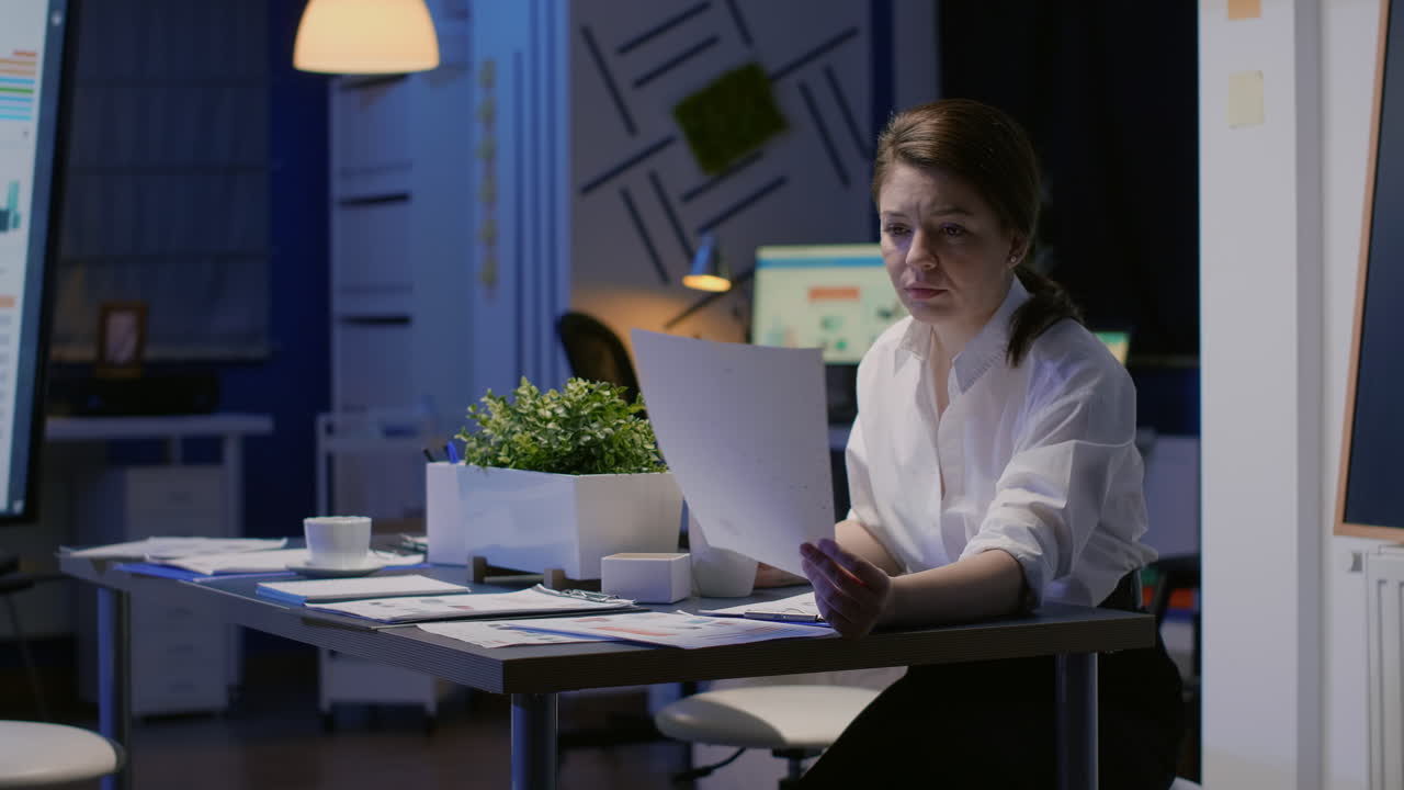 Executive businesswoman looking at company profit presentation on monitor