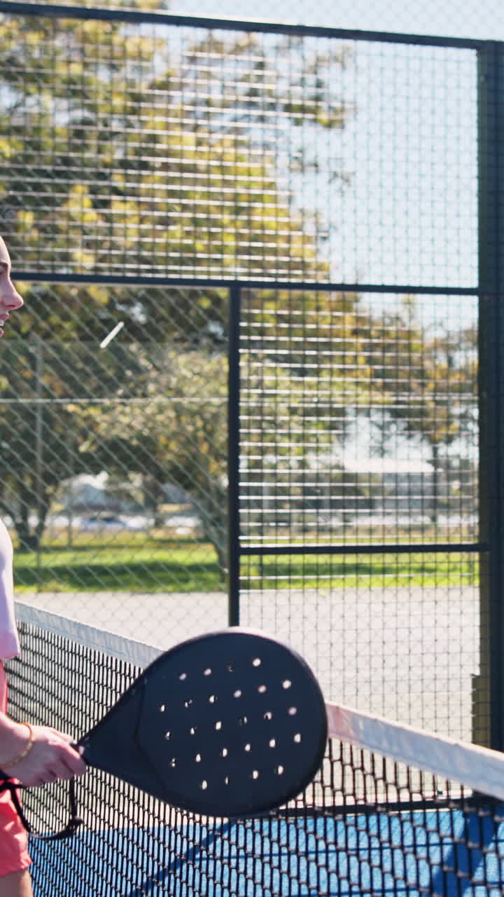 Young Women Playing Padel Tennis on an Outdoor Court