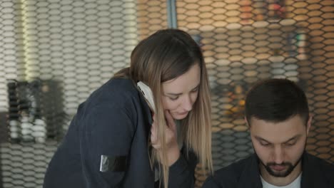 female manager discussing vehicle repair with mechanic in auto repair shop