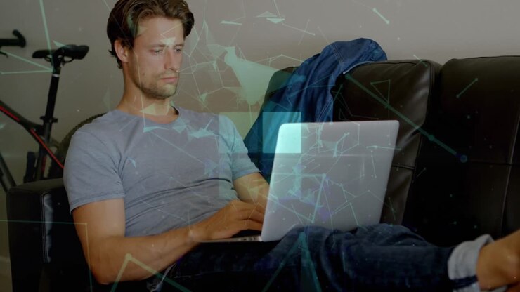 Animation of squares and connected dots forming geometric shape, caucasian man using laptop