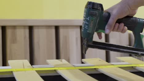 assembling a bed frame with a nail gun