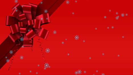 animación de nieve cayendo sobre la cinta sobre un fondo rojo