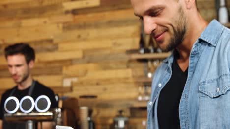 Man-using-digital-tablet-at-counter-4k