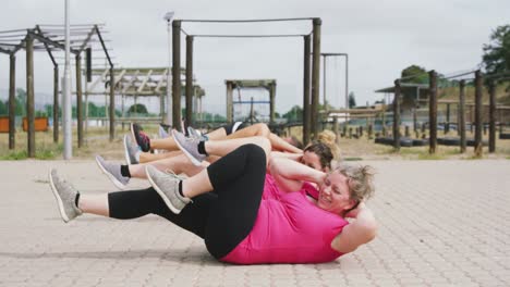 Female-friends-enjoying-exercising-at-boot-camp-together