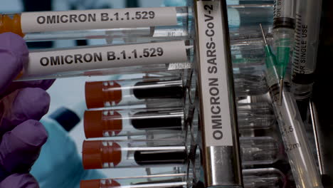 Test-tubes-marked-with-Omicron-label-for-sample-collection-and-testing,-extracted-from-stand