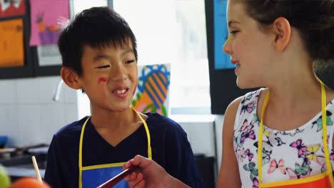 smiling schoolkids practicing drawing in drawing class