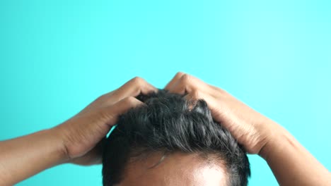 man styling his wet black hair