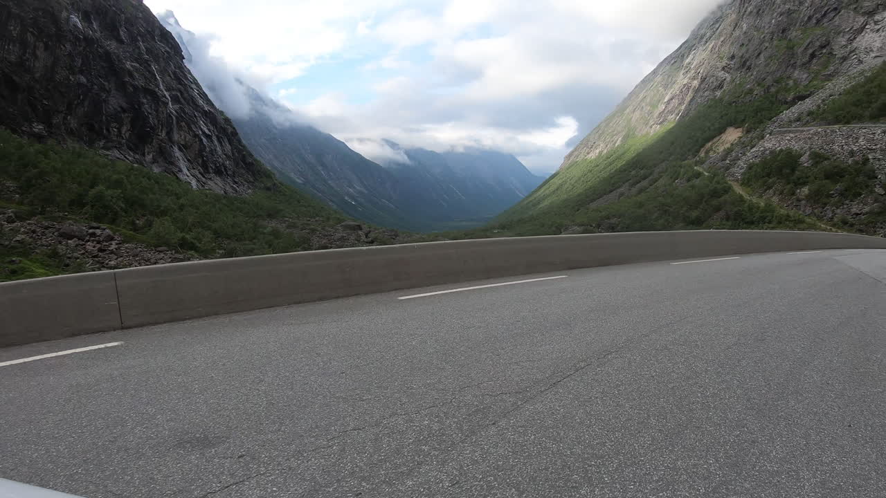 Driving On Serpentine Mountain Road Of Trollstigen In Norway And Passing By The Dangerous Hairpin Bend At Daytime. POV
