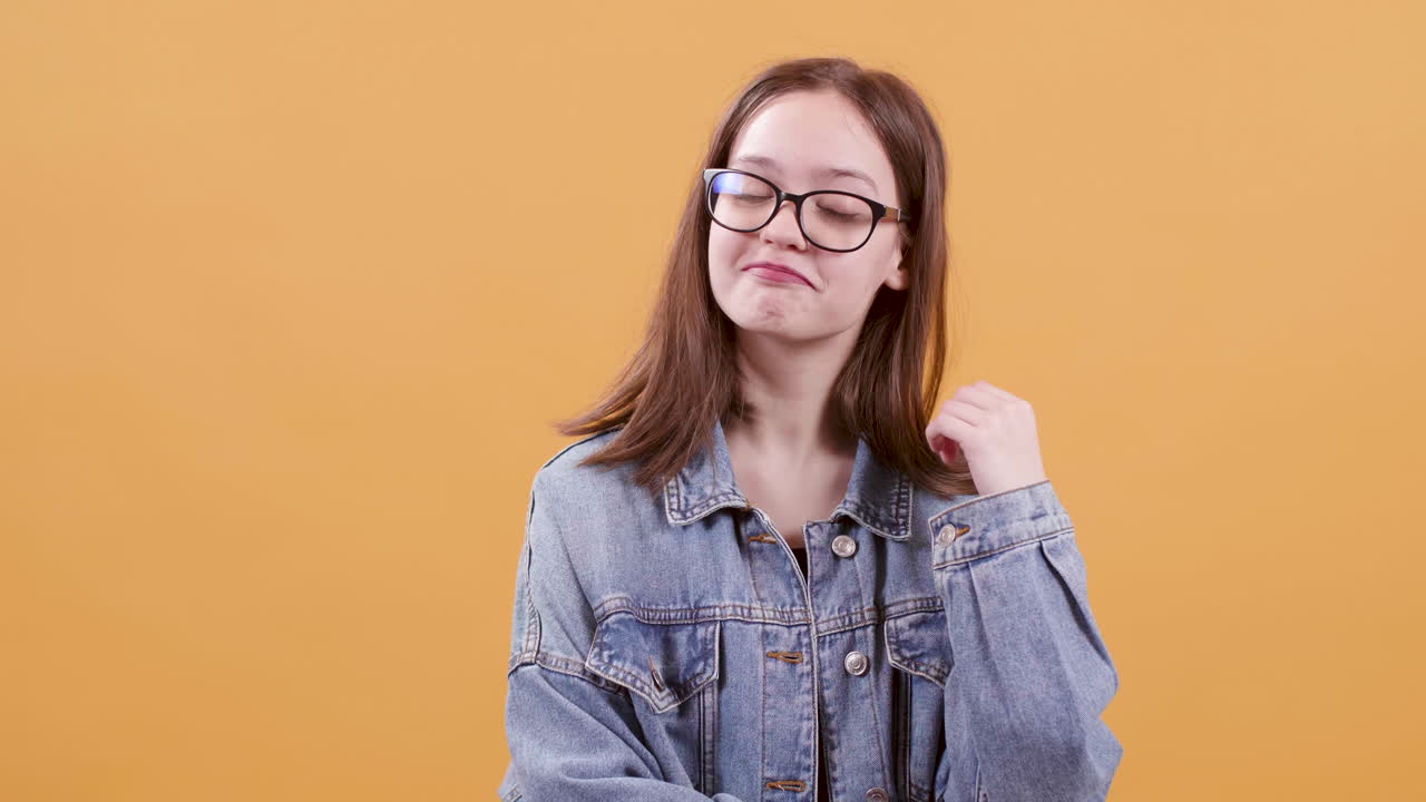 Teenage girl in denim jacket with eyeglasses