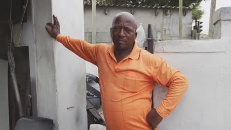 african man leaning on the wall