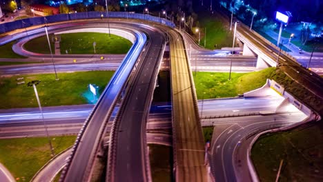 night timelapse aerial view of a freeway intersection traffic trails in night moscow