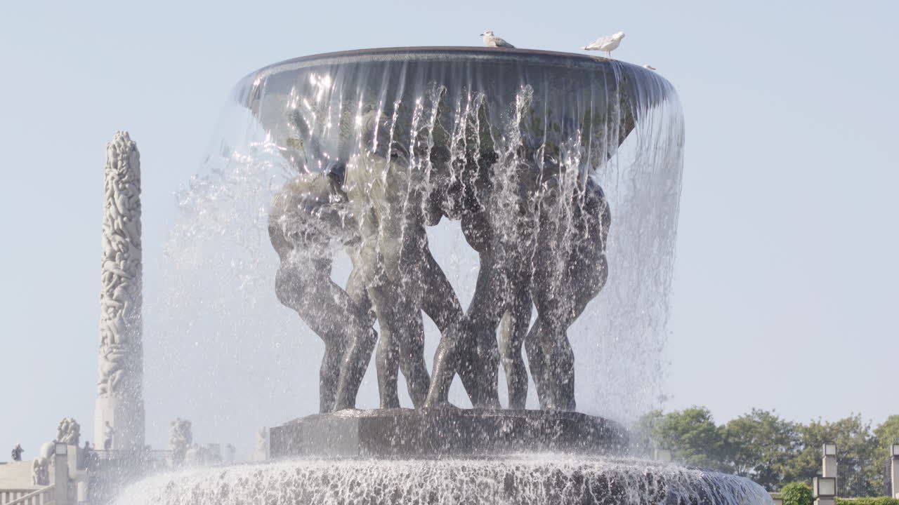 Slow motion tilt up of The Fountain in The Vigeland sculpture park, Oslo, Norway