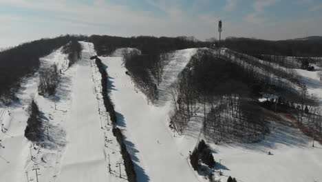 drone view of ski resort during snowy winter