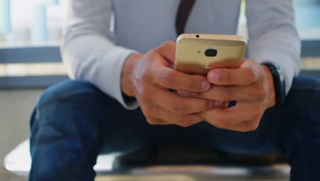 Male-commuter-using-mobile-phone-in-waiting-area-4k