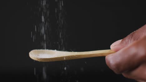 video of cook throwing salt on the table on black background