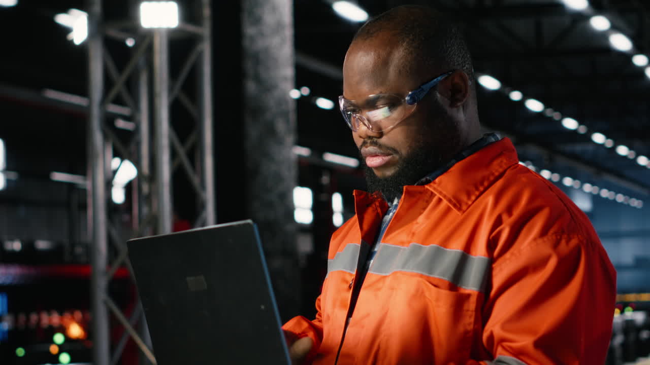 Factory personnel inspecting steel machinery in a warehouse plant