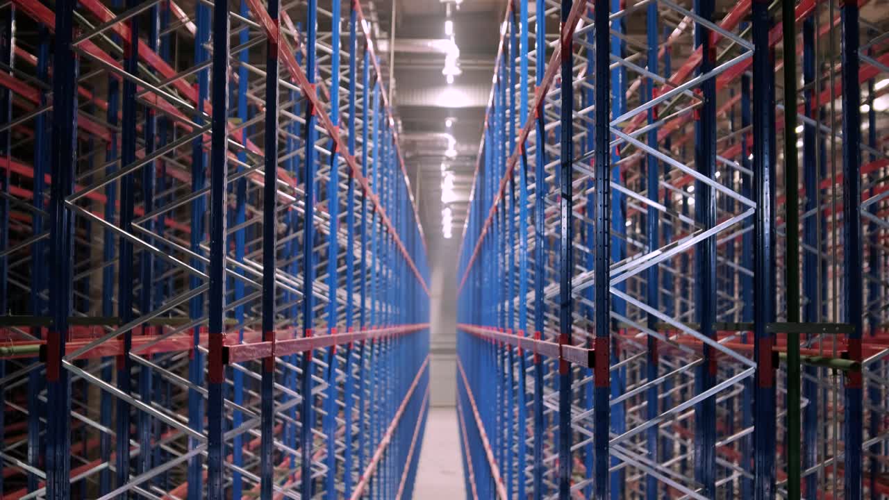 gran y moderno almacén en construcción, con estanterías metálicas y otros equipos industriales.