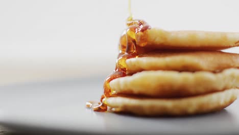 video of pancakes with maple syrup on white plate seeing from above