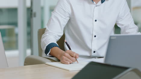 young asian businessman intern writing notes in journal brainstorming problem solving strategy making to do list reminder in office workplace 4k