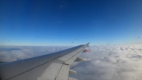 a scenic view of clouds from a window of a flying aircraft