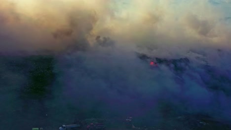 Vista-Aérea-De-Un-Bombero-Trabajando-En-Medio-Del-Humo,-Tratando-De-Calmar-Un-Incendio-Forestal.