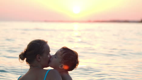 lovely mother and little son swimming in sea