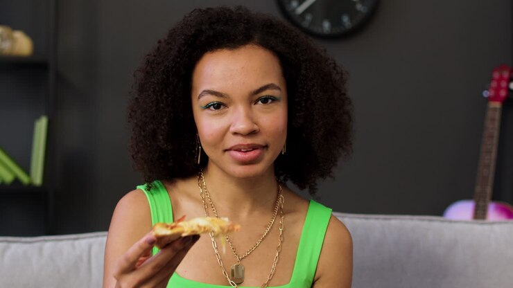 Woman holding pizza slice