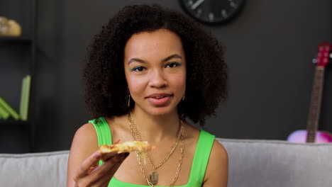 woman holding pizza slice