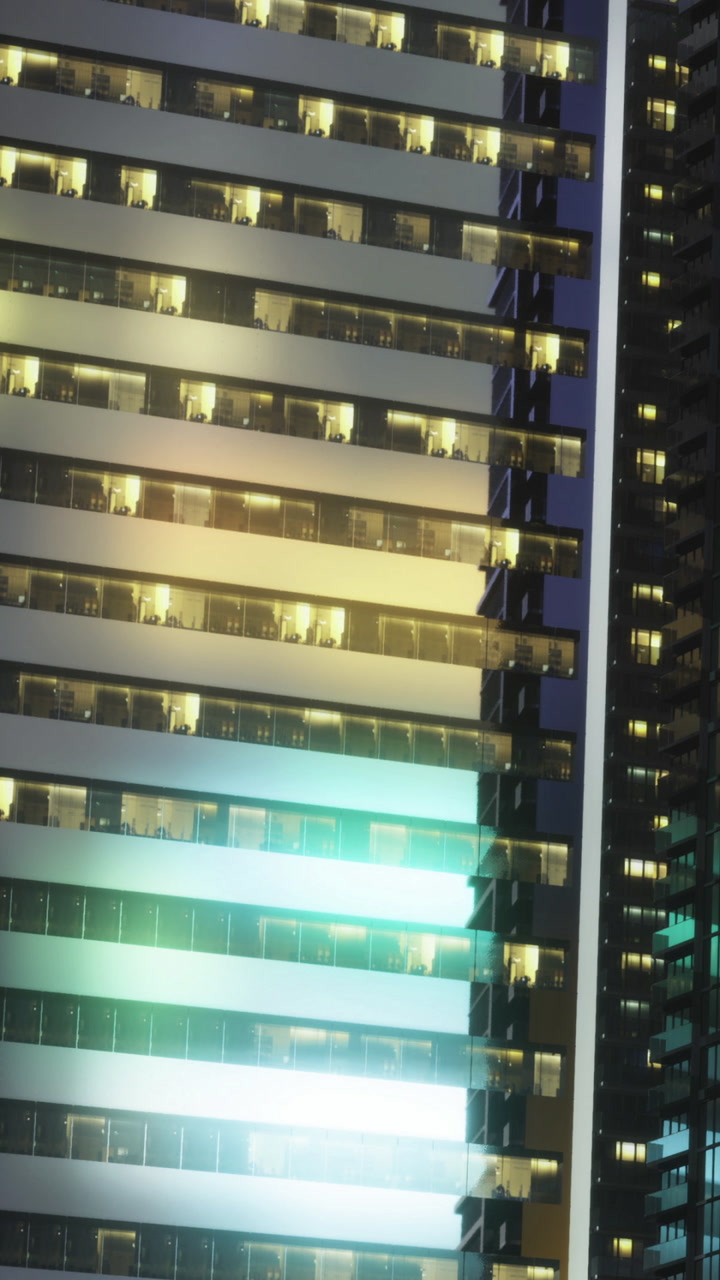Night view of a high rise building with lit windows in a cityscape