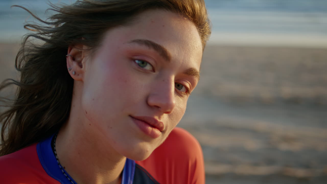 Surf girl relaxing beach portrait. Sportswoman in protective suit looking sea