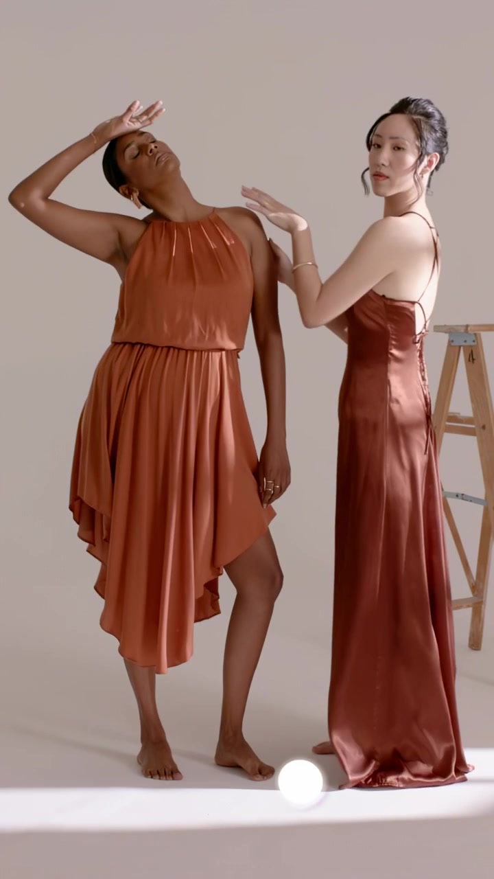 Video verticale: Due modelli in posa in uno studio beige, con cornici che creano anelli scintillanti in sovrimpressione, mostrando la moda.