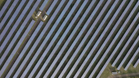 aerial view flying over solar panel farm on a sunny day, the future of green renewable energy is the sun