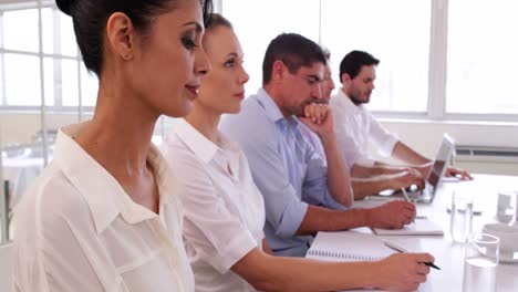 Stern-business-team-listening-to-a-presentation-