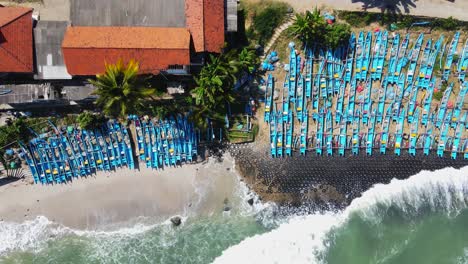 Aerial-top-down-drone-shot-of-many-boats-parked-on-the-beach