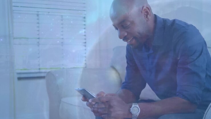 Animation of globe over african american businessman using smartphone