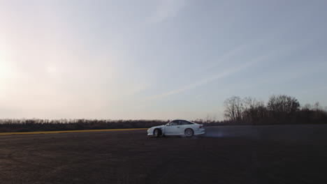 white car drifting on an open road