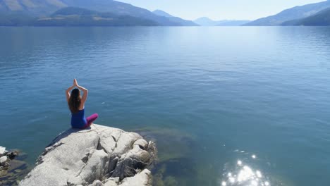 Woman-performing-yoga-on-at-lake-shore-4k