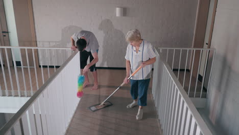 couple cleaning a hallway