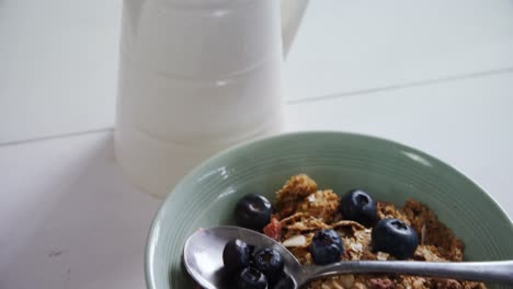 Breakfast-cereals-in-bowl-with-milk-jug-4k