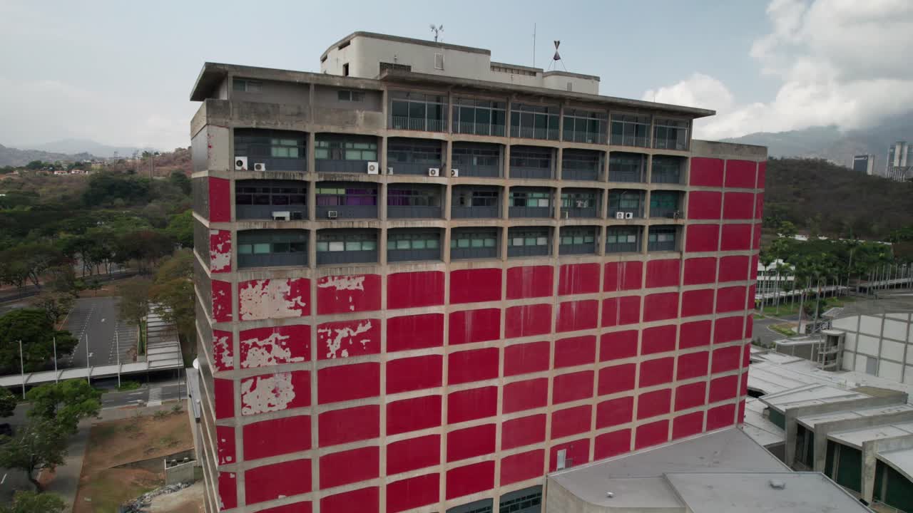 Modernist red building facade of Biblioteca Central UCV, iconic Caracas university library