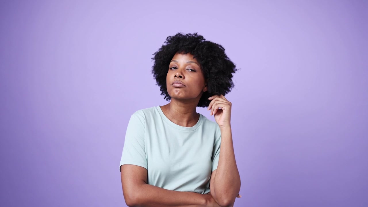 Thoughtful African American Woman Pondering on a Purple Background