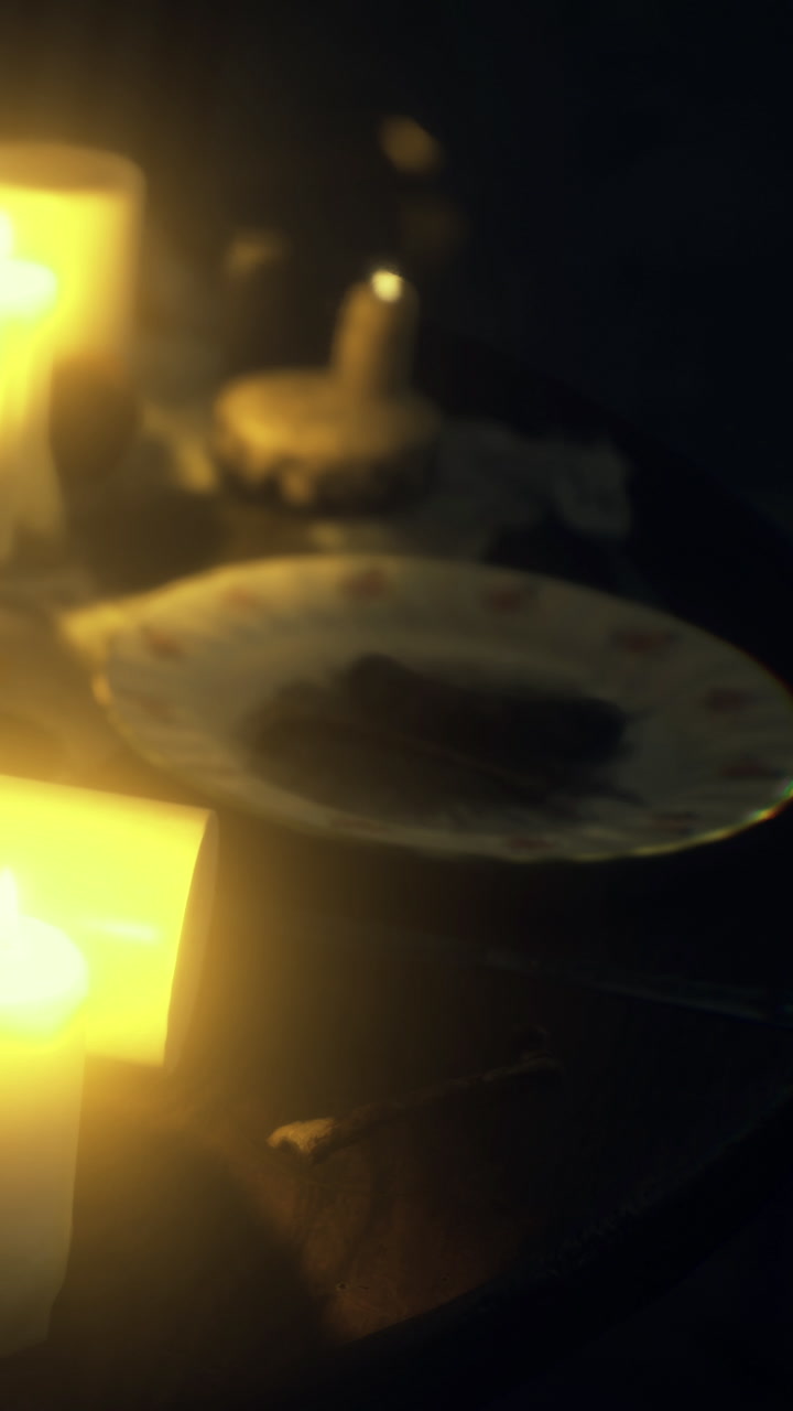 Candlelight dinner with a plate and dessert on a table near soft light