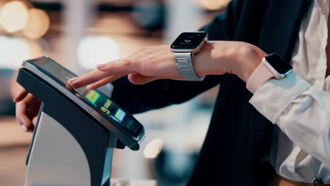 person interacting with a device while wearing two smartwatches
