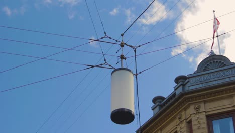 electricity line with floating pole, copenhagen denmark flag and eighteen ninety two year mdcccxcii in roman numerals with a blue sky