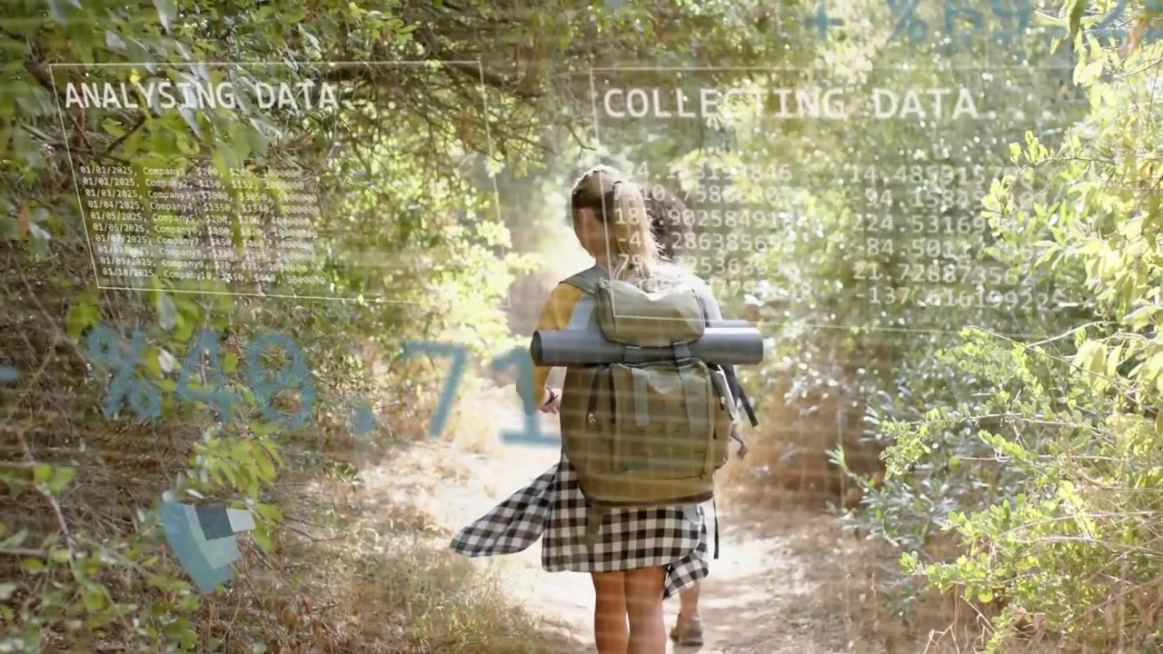 Two female hikers walking sunlit trail, wearing backpack with mat, activating HUD analysing data