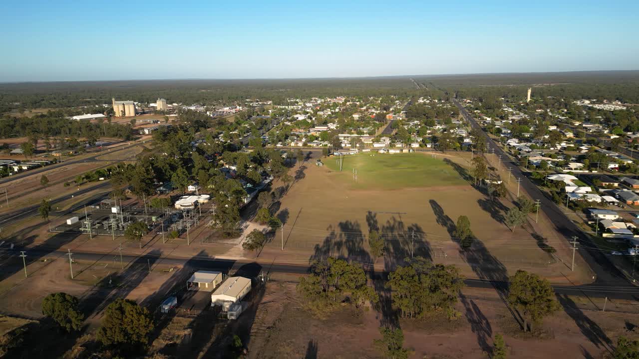 Approaching aerial views over residential housing and sporting fields in the small town of Miles Queensland.